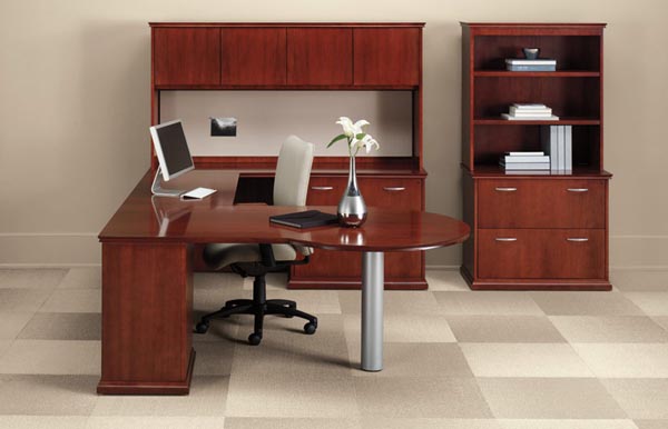 Executive "P" Top "U" desk consisting of a "P" top table, bridge, lateral file credenza with overhead storage with doors and tack board. To the right is a lateral file with bookcase hutch.