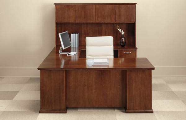 Executive "U" desk consisting of a single pedestal desk, bridge, single pedestal credenza with overhead storage with doors