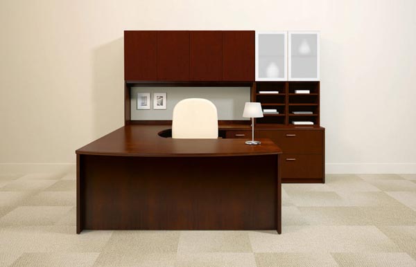 Executive bow front "U" desk consisting of a bow front extended single pedestal desk, extended corner, single pedestal return, lateral file with organizer and frosted glass storage unit, overhead storage hutch with doors and a tack board