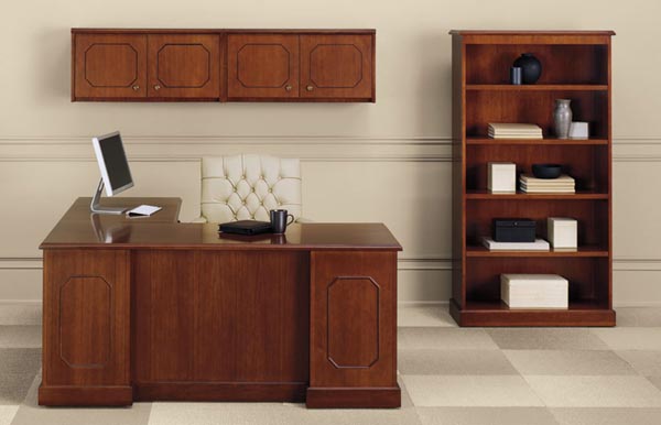 Executive "L" desk with an overhead wall mounted storage unit with doors and matching bookcase.