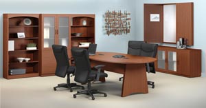 Conference room suite consisting of race track conference table, buffet, conference cabinet with white erase board, two bookcases and a storage bookcase cabinet with frosted panel doors shown in Cherry laminate finishes.