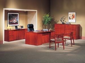Bow front executive desk, storage credenza and two three drawer lateral files shown in Light Cherry. 
