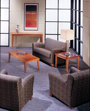 Reception lounge area consisting of sofa, emd and coffee tables with love seat and club chairs.