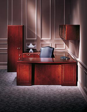 Single Pedestal Desk - Right with Bow Top, Executive Bridge Top and Modesty Panel, Rectangular Worksurface and Modesty Panel, and Modular Multi-File Pedestal. 108-inch Hanging Cabinet with Glass Doors and Organizer Wardrobe shown in Cordovan Cherry