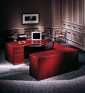 Single Pedestal CRT Desk Left with Bow Top, Executive Bridge Top and Modesty Panel, Single Pedestal Credenza shown in Light Cherry.